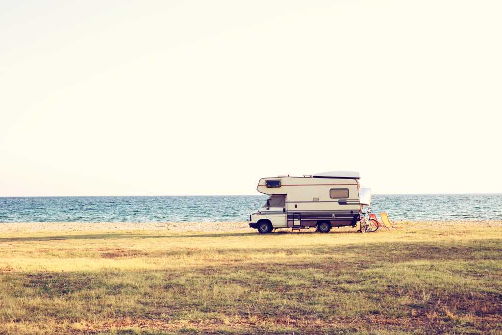 A vintage shoot with a motorhome caravan car near the Mediterranean sea in a beautiful summer day.